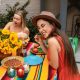 woman in red sleeveless dress sitting on chair eating