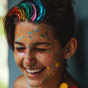 shallow focus photo of woman smiling with face paint