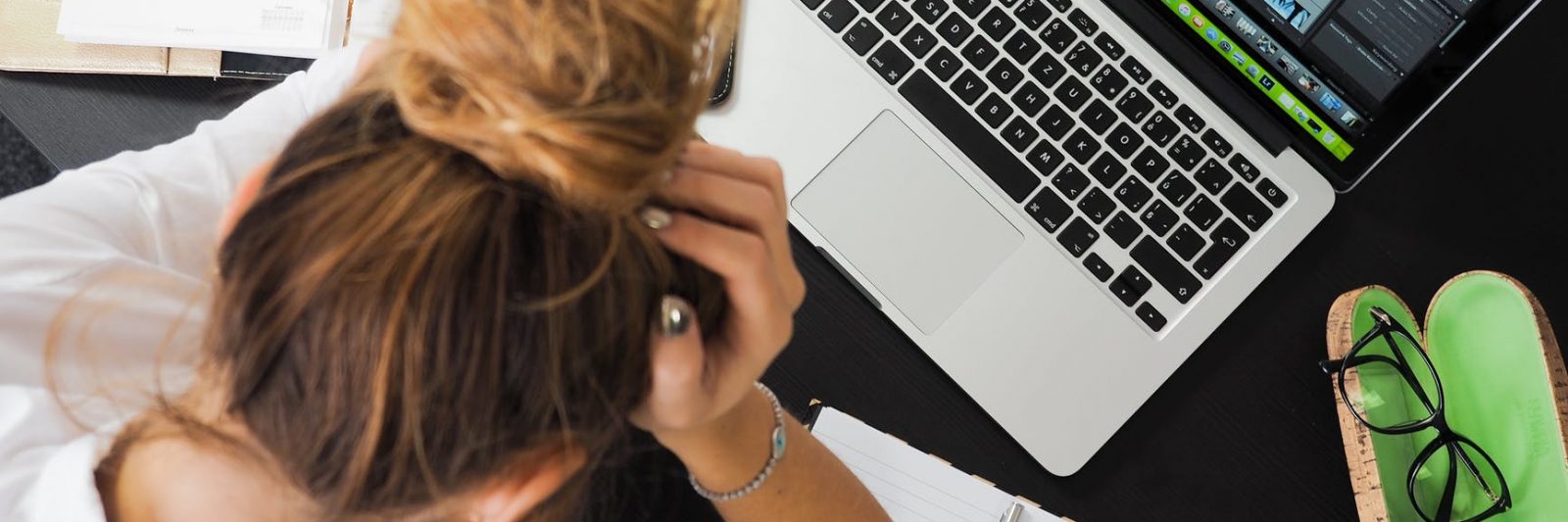 woman sitting in front of macbook