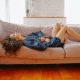 woman suffering from a stomach pain lying down on couch