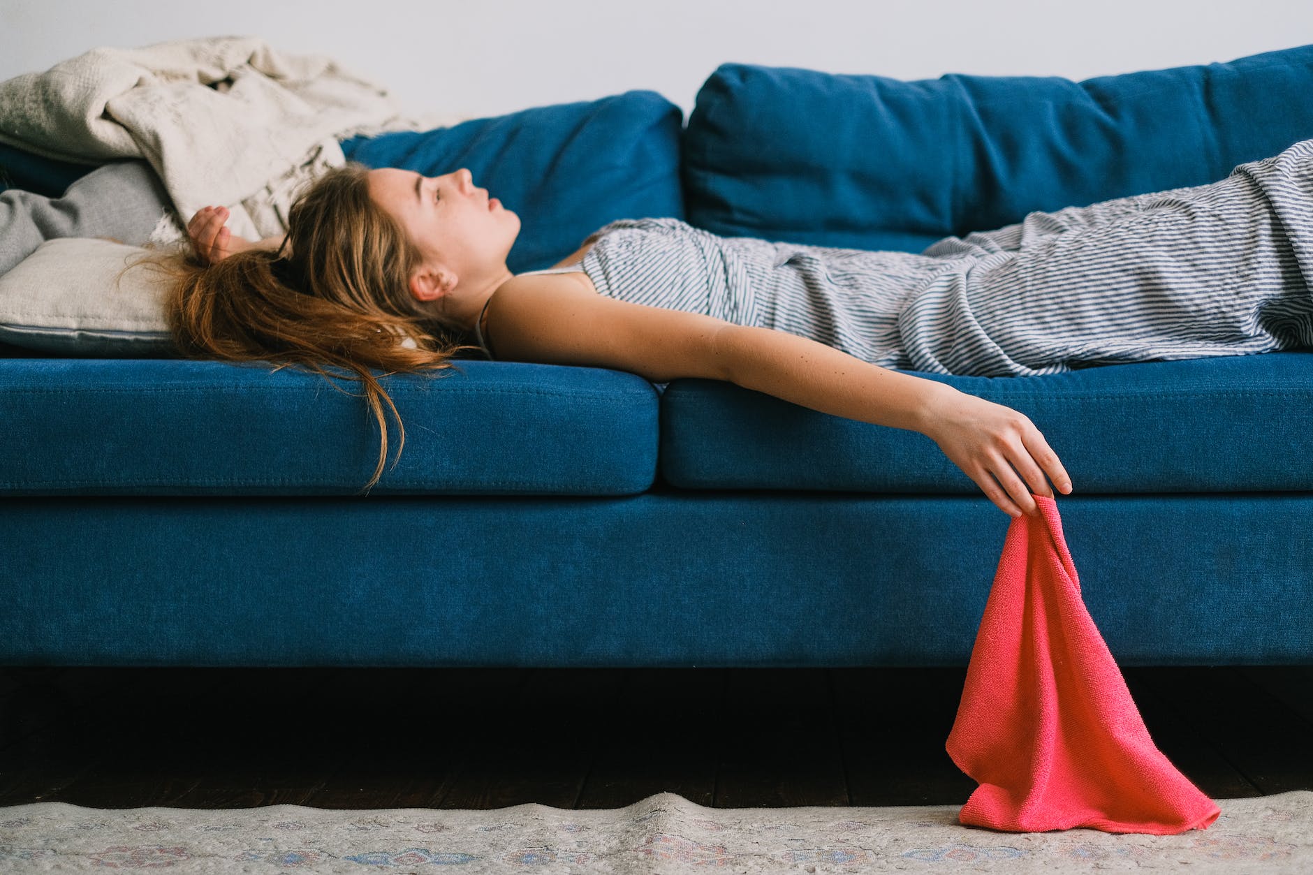 tired housewife resting on sofa after housework