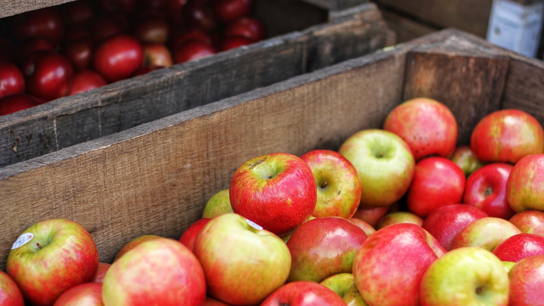 red and green apples in brown wooden box